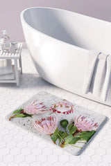 Floral pink Proteas on white bathmat