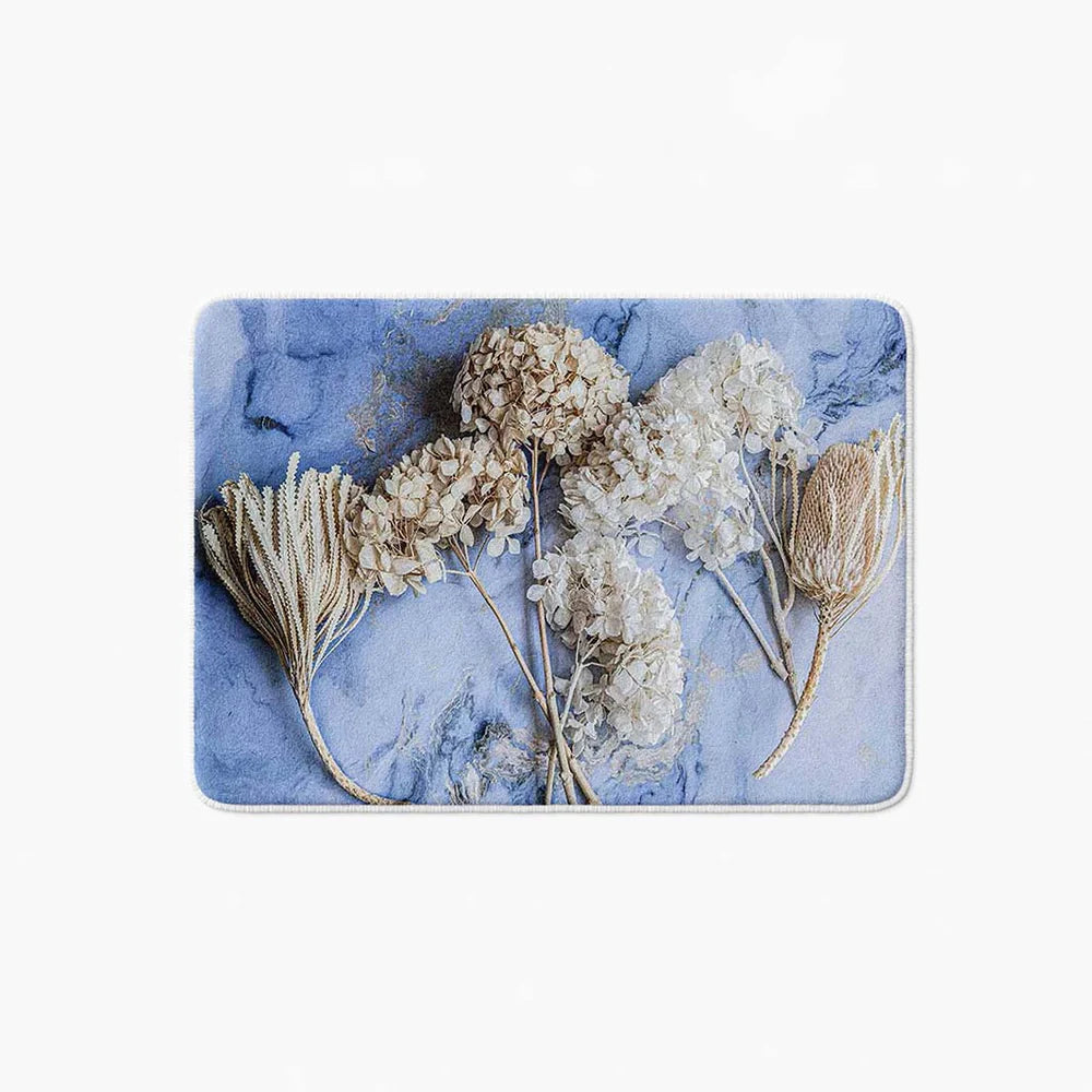 Floral cream bleached hydrangeas on blue bathmat