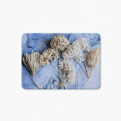 Floral cream bleached hydrangeas on blue bathmat