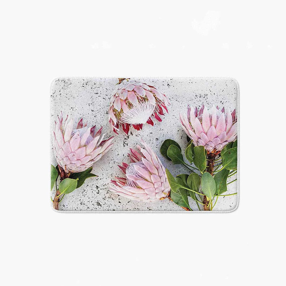 Floral pink Proteas on white bathmat