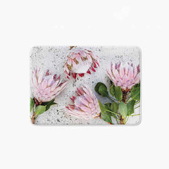 Floral pink Proteas on white bathmat